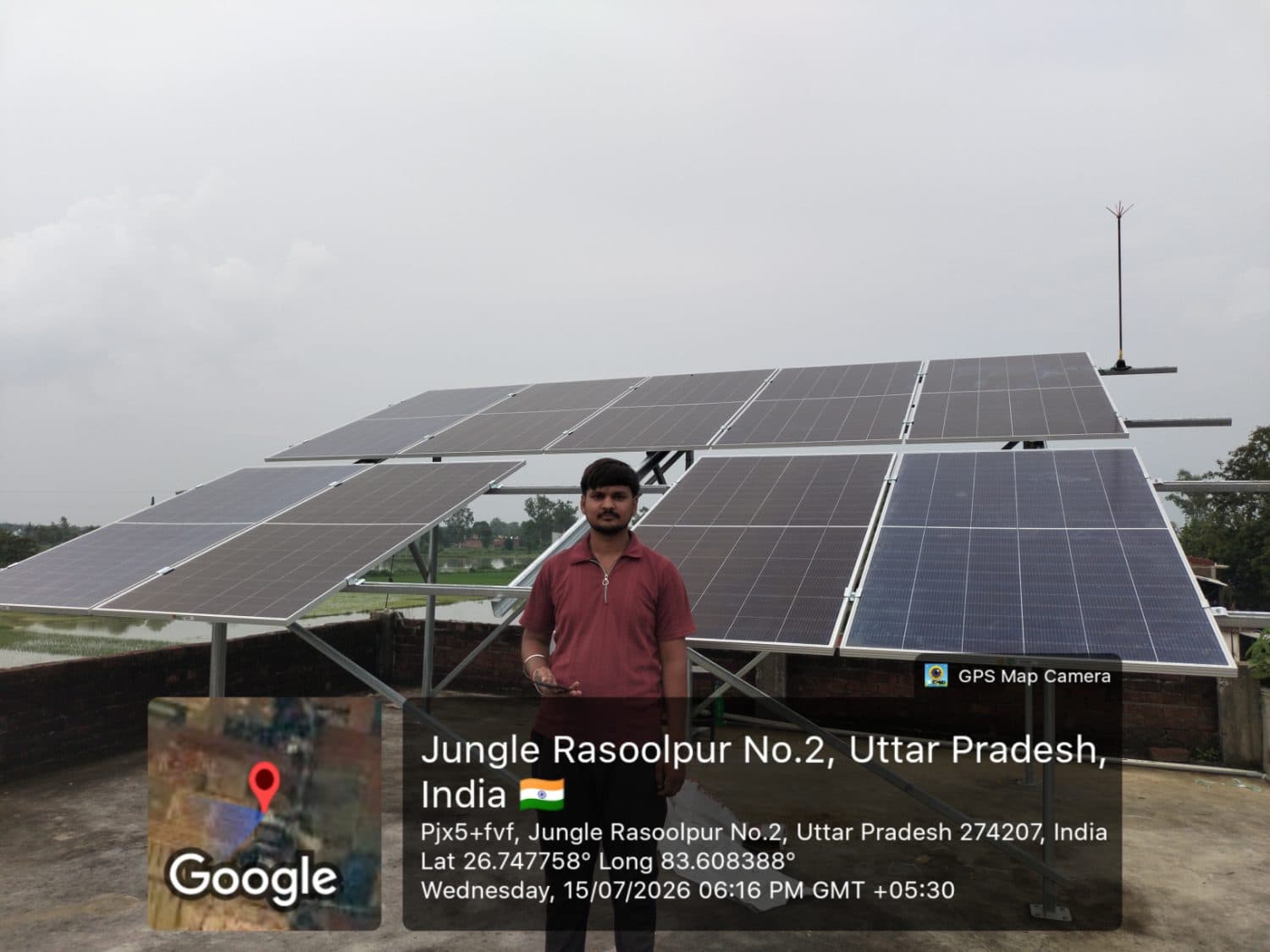 Customer beside completed rooftop solar array in Jungle Rasoolpur, Uttar Pradesh