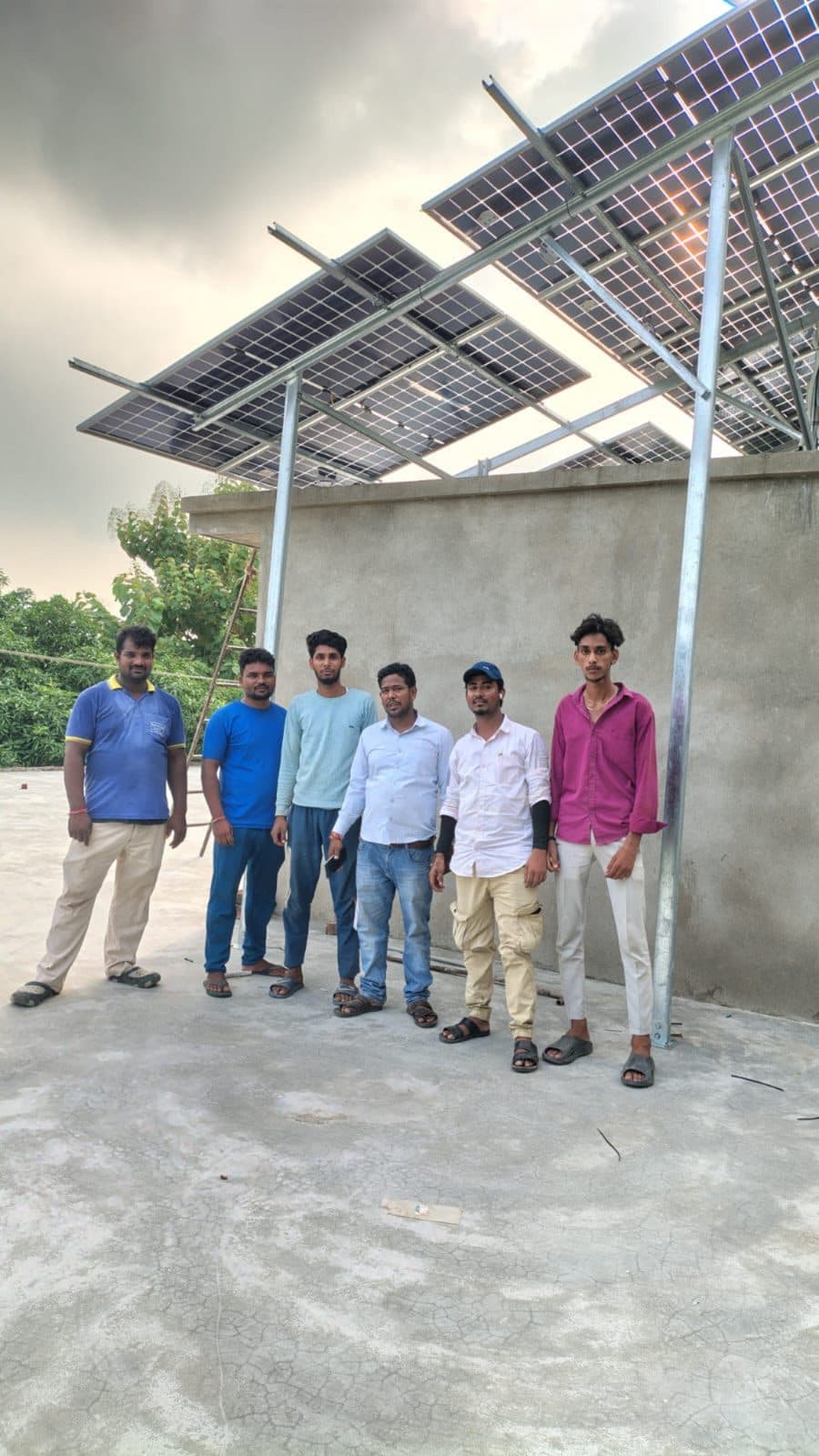 Anand Solar Energy Point installation team under a completed elevated solar structure